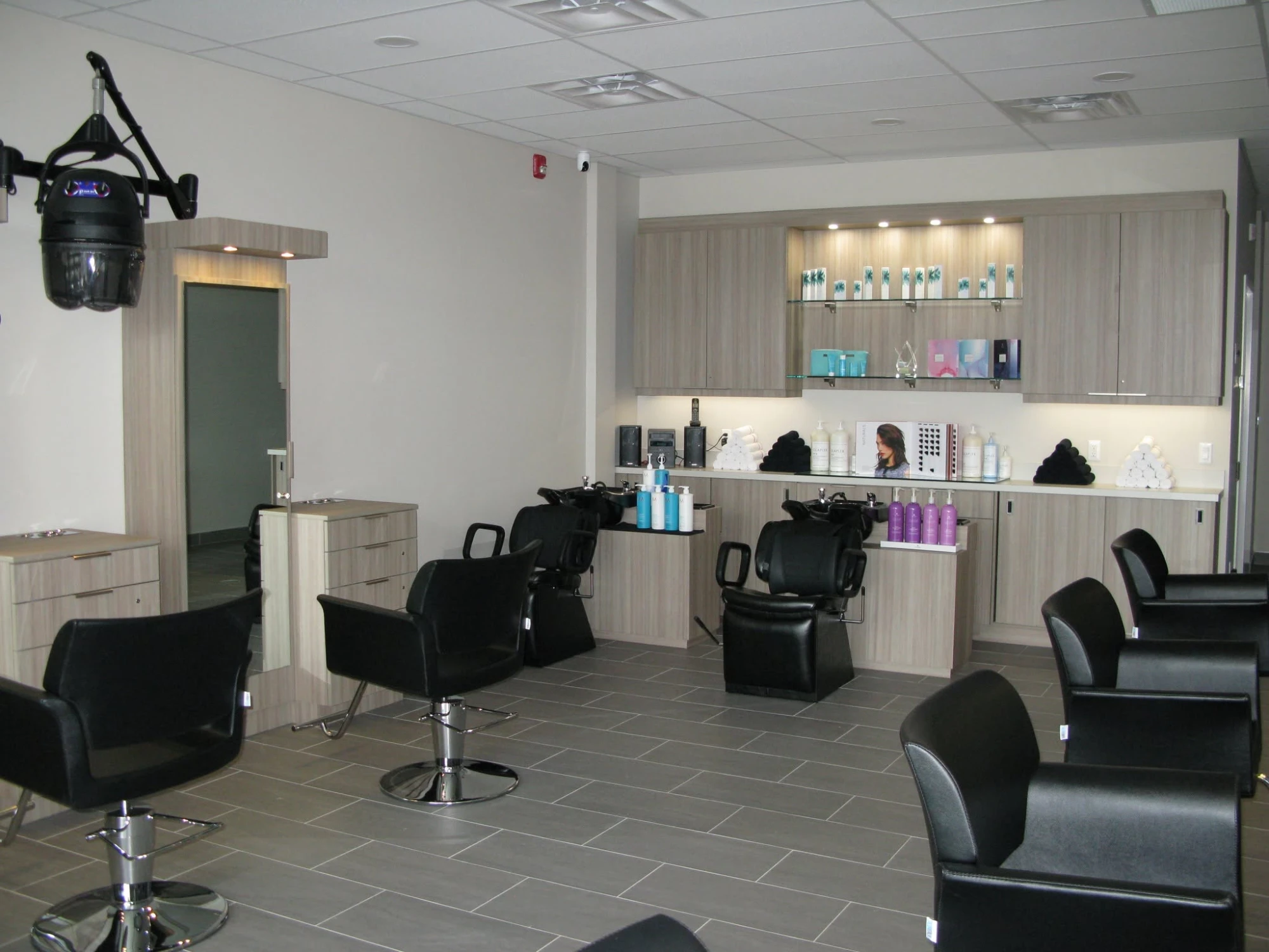 The wash area with two shampoo chairs, and styling stations at Friendly Cuts Kanata